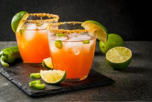 Alcohol. Traditional Mexican South American cocktail. Spicy michelada with hot jalapeno peppers and lime.